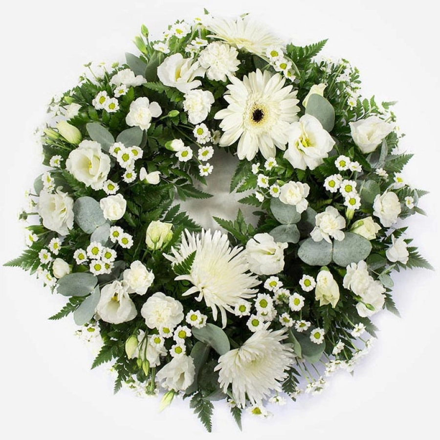 wreath-featuring-white-chrysanthemum-blooms-white-gerbera-white-lisianthus-white-spray-carnations-on-a-grey-background-1