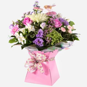 pink-gift-box-with-a-vibrant-arrangement-of-pink-purple-and-white-fresh-flowers-1