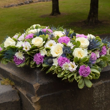 pillow-shaped-tribute-with-lilac-and-white-flowers-1
