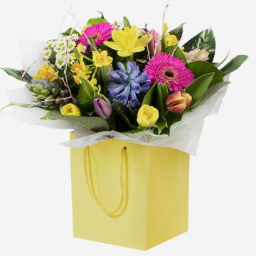 a-cheerful-spring-bouquet-with-daffodils-hyacinths-and-gerberas-in-a-yellow-gift-bag-1