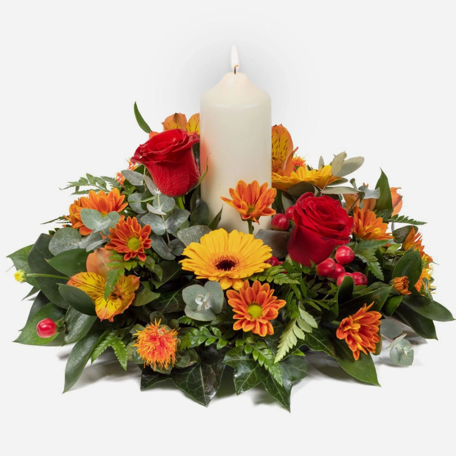 Golden diya-diwali centerpiece with red roses orange gerberas and a white candle surrounded by vibrant seasonal flowers and greenery diwali centerpiece with red roses orange gerberas and a white candle surrounded by vibrant seasonal flowers and greenery g