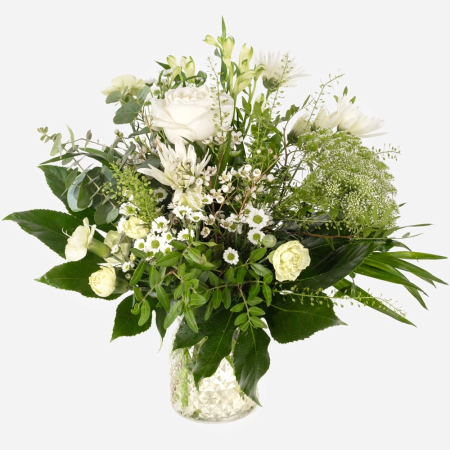 Elegant winter bouquet arranged in a clear textured glass vase elegant winter bouquet arranged in a clear textured glass vase elegant winter bouquet arranged in a clear textured glass vase